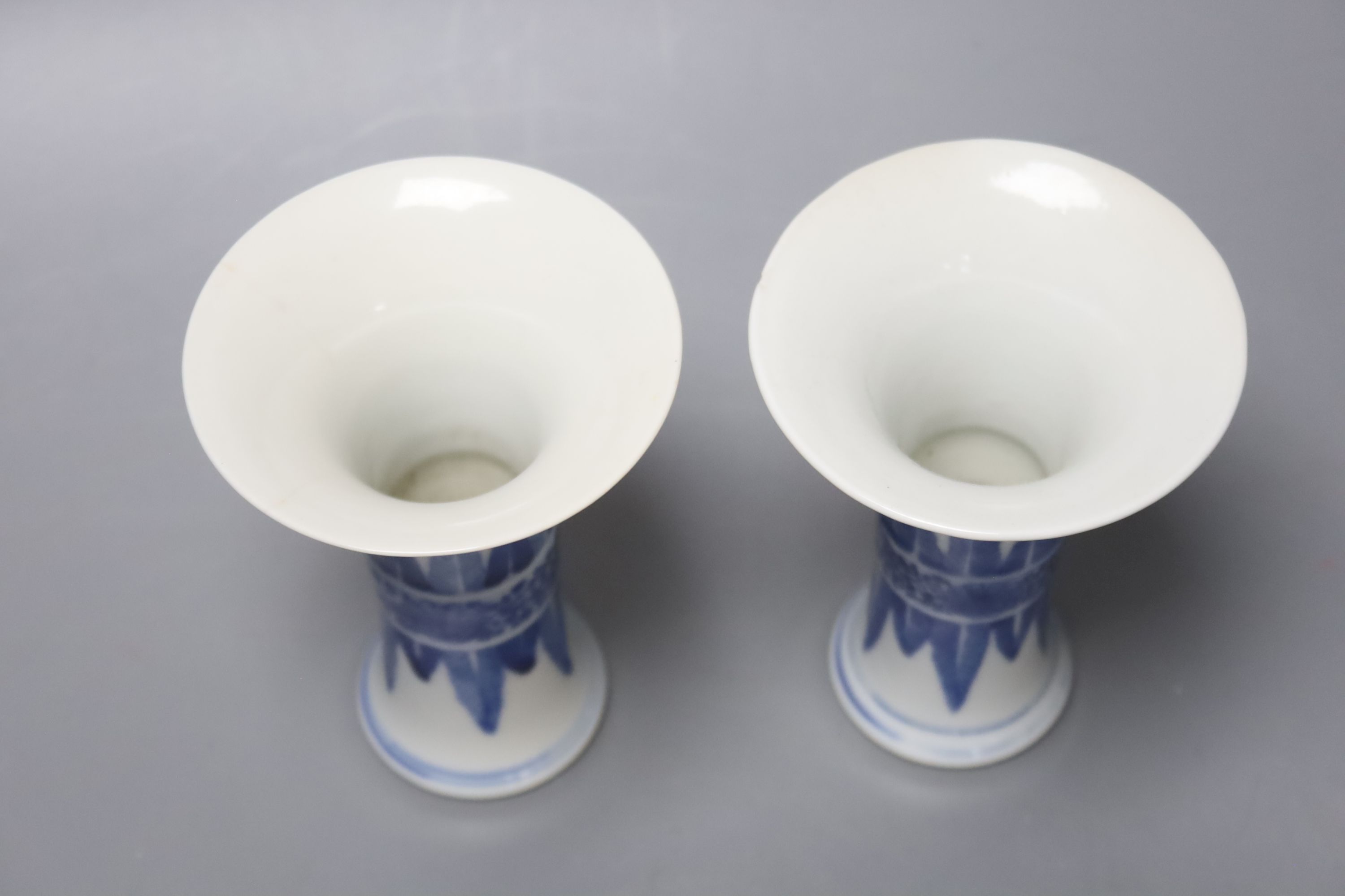 A pair of Chinese blue and white small beaker vases, Kangxi mark but c.1900, height 12cm